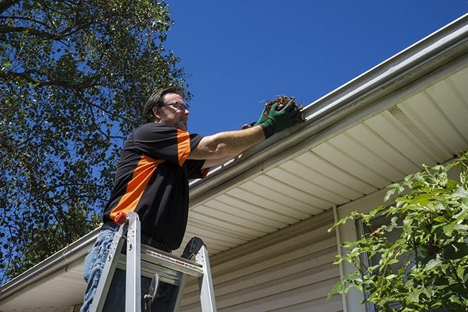 gutter being fixed by a maintenance person in Lincoln Park